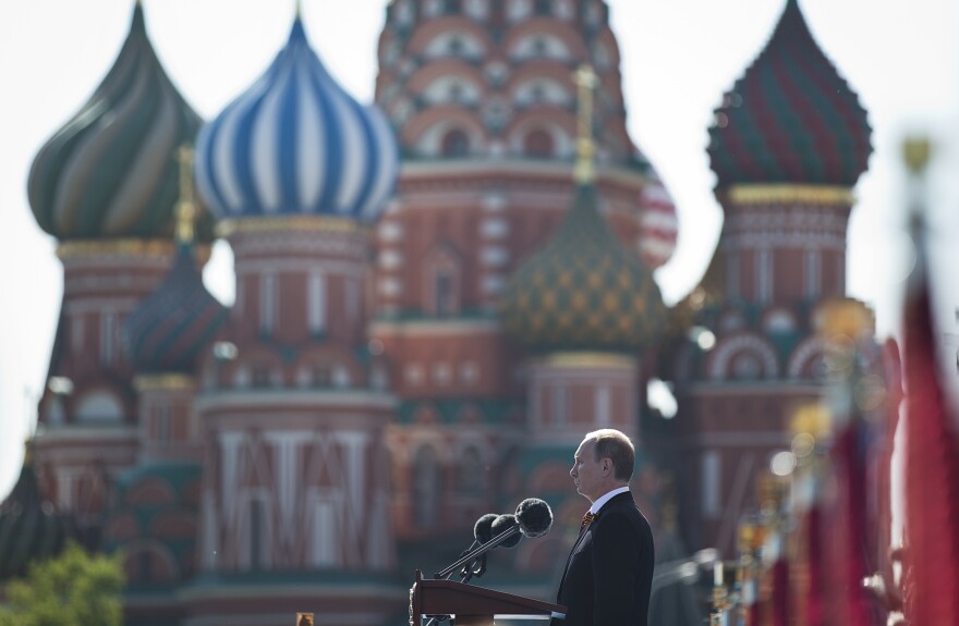 Russian President Vladimir Putin speaks during a Victory Day parade, which commemorates the 1945 defeat of Nazi Germany, with St. Basil's Cathedral in the background.