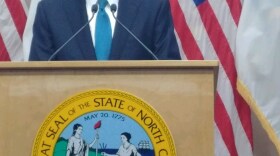 Gov. Roy Cooper addresses reporters on Tuesday, December 18, 2018.