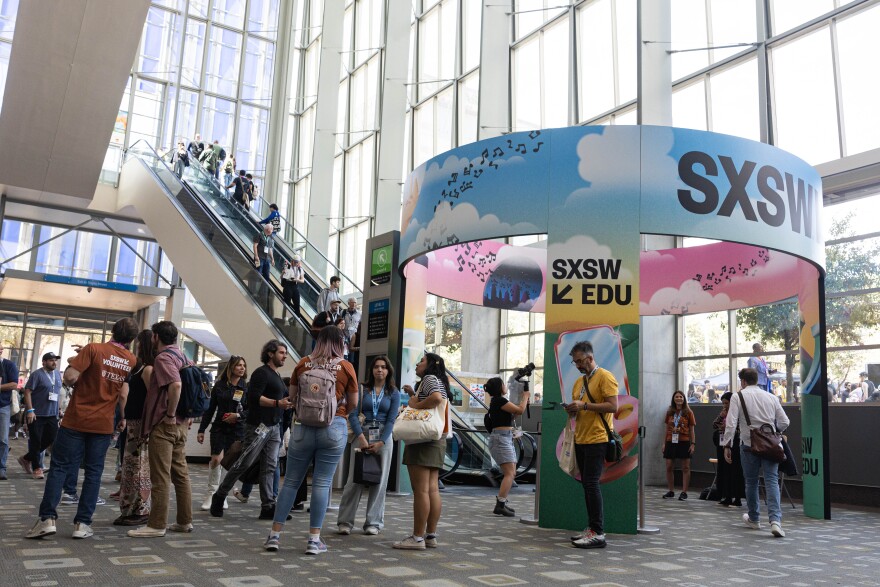 SXSW attendees in 2025 ride an escalator at the Austin Convention Center, which has since been demolished and is being rebuilt. The festival and conference drew 309,327 participants last year, according to festival organizers.