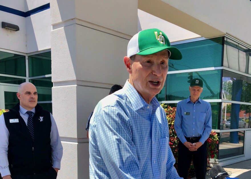 At Monday's press conference, Wyden heard from Brian Steffen, left, from the YMCA and Tom Mulhern, right, from Food for Lane County, about how gas prices affect parents who rely on childcare and Meals on Wheels drivers, respectively.