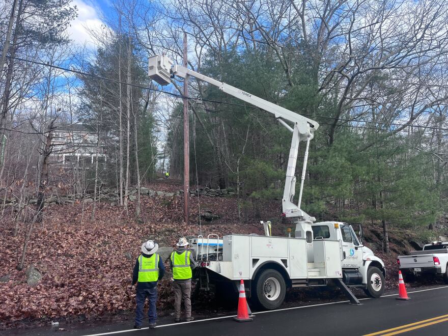 Crews work to restore power on Tuesday.