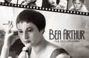 A black and white poster has black lettering and a photo of a woman with short dark hair who is holding a cigarette.