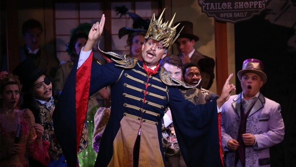 An actor from Mikado with a golden crown.
