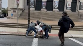 Javier Serrano Pujols is on the ground being tacked by federal ICE agents who detained him outside City Hall and the Roderick Ireland Courthouse in Springfield May 7th.