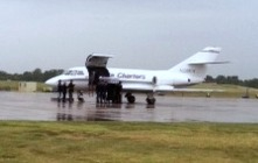 The Private's body is carried by an honor guard from an airplane at Tulsa's Air Guard Base.