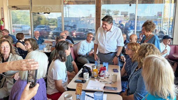 Gov. JB Pritzker speaks to Emily Waugh of Oregon at Lulu’s Diner in Springfield on Thursday, Aug. 27, 2026.