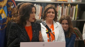 Tammy Meyers and 11-year-old Corryn watch Governor Gretchen Whitmer at the ceremony to sign legislation to lift Michigan’s 35-year-old ban on paid surrogacy contracts. The Meyers family has three children conceived via in vitro fertilization.