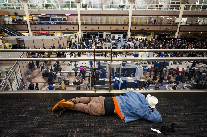 A traveler sleeps on the floor of Denver International Airport on Thursday morning when the temperature dropped to minus 24 degrees Celsius.