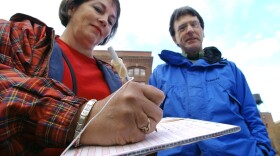 Mary Champine, left, adds her signature to a petition in Washington state (file photo).