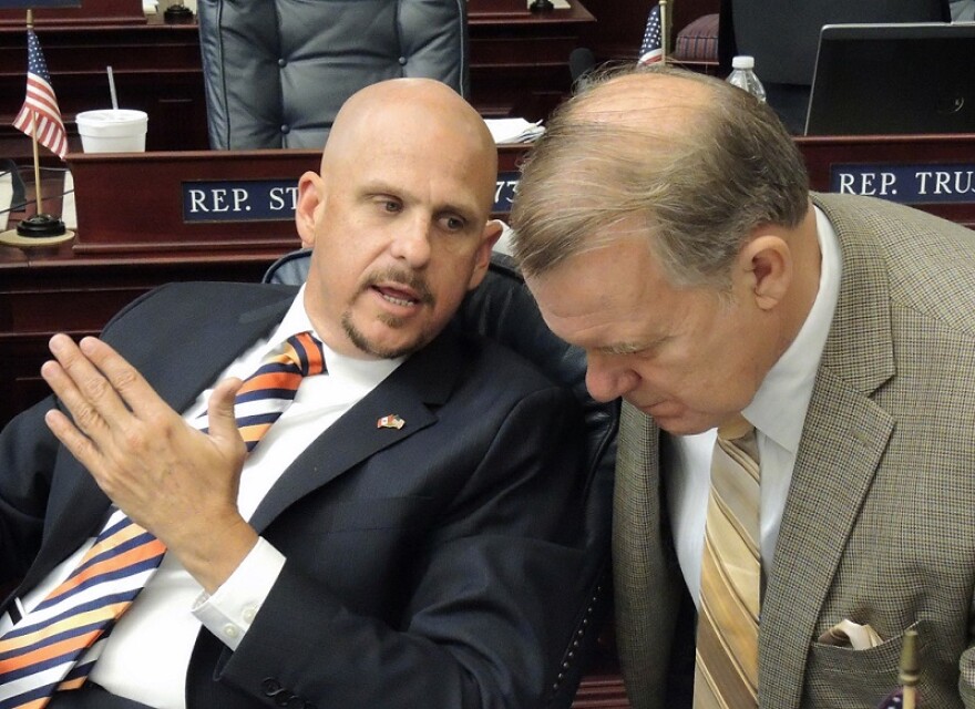 From the left Rep. Ritch Workman, R-Melbourne, and Rep. Douglas Vaughn "Doug" Broxson, R-Midway, debates on the House floor March 22, 2013.