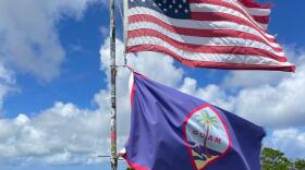 A U.S. flag and a Guam flag fly on Mount Lamlam, Guam, on July 4, 2025.