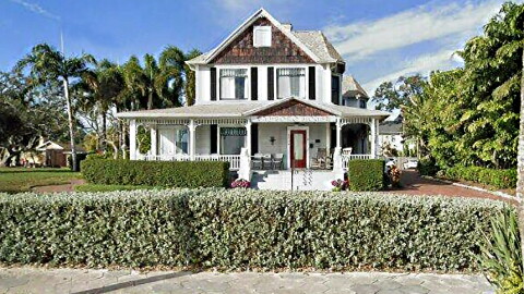 Photo of a two-story house with trees around it 