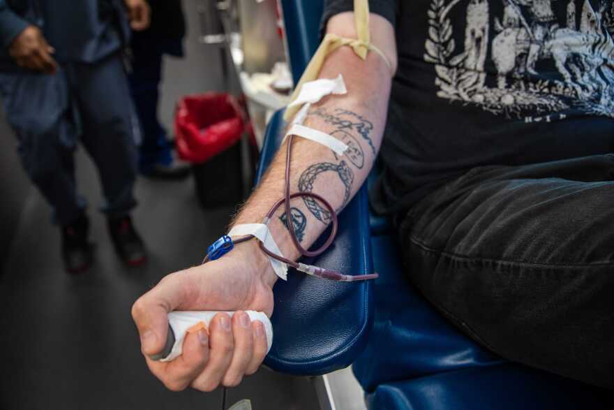 A donor gives blood at The Blood Center's truck on Canal Street in New Orleans on Thursday, Jan. 2, 2025. People lined up at the center to give blood after the New Year's Day attack on Bourbon Street that killed 14 people and injured dozens of others.