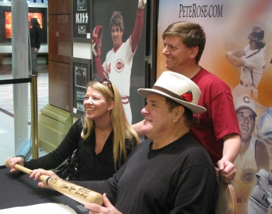 Pete Rose (front, right) poses with fans Scott and Tiffany Van Alstyne at the Art of Music memorabilia store in Las Vegas. Every week, he goes to the store to sign autographs.