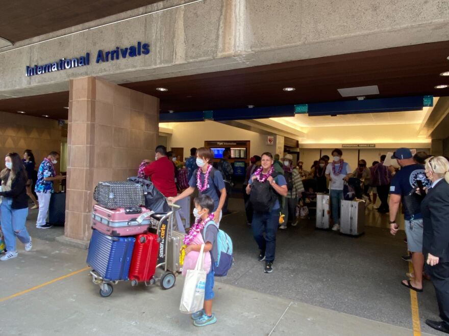 Travelers from Japan arrive in Honolulu on the All Nippon Airways plane designed to look like a honu, or turtle.