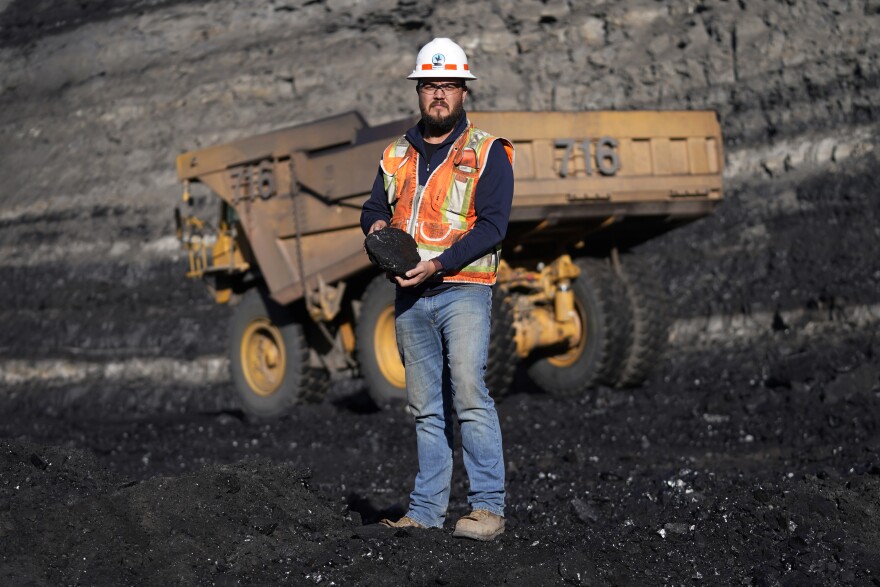 Sean Hovorka, a production superintendent at Trapper Mining, looks on as coal is hauled from the mine Nov. 18, 2021. Hovorka, also recently elected member of the town's city council, sees a future in mining because of renewables.