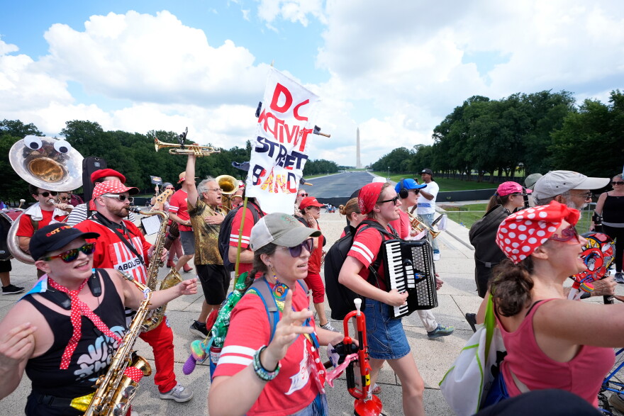 A group of local activist from Washington DC, demonstrating during the March on Washington rally at the Lincoln Memorial on the National Mall, Friday, Aug. 28, 2026 in Washington.