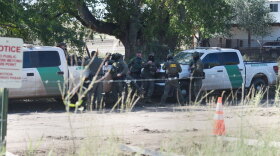 Border Patrol agents gather below the "Abuela," another old-growth cottonwood tree just across the border from Lochiel, in La Noria, Mexico, where protesters have set up another tree-sit on Oct. 7. 2026. A cottonwood on the U.S. side, dubbed the "Grandmother" by activists, was felled this week.