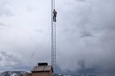 Volunteer Eric McGregor scales Weber Canyon's new radio tower to unhook a winch cable after it was installed May 13, 2026.