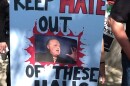 A protester holds a sign opposing Rush Limbaugh's planned induction into the Hall of Famous Missourians.