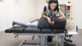 A chiropractor adjusts a patient. Some people are choosing chiropractic treatment instead of prescription opioids to deal with pain relief.