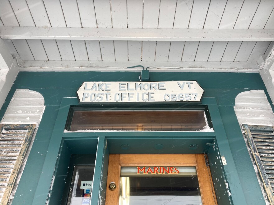 A handpainted sign above a door reads 'Lake Elmore VT Post Office 05657'