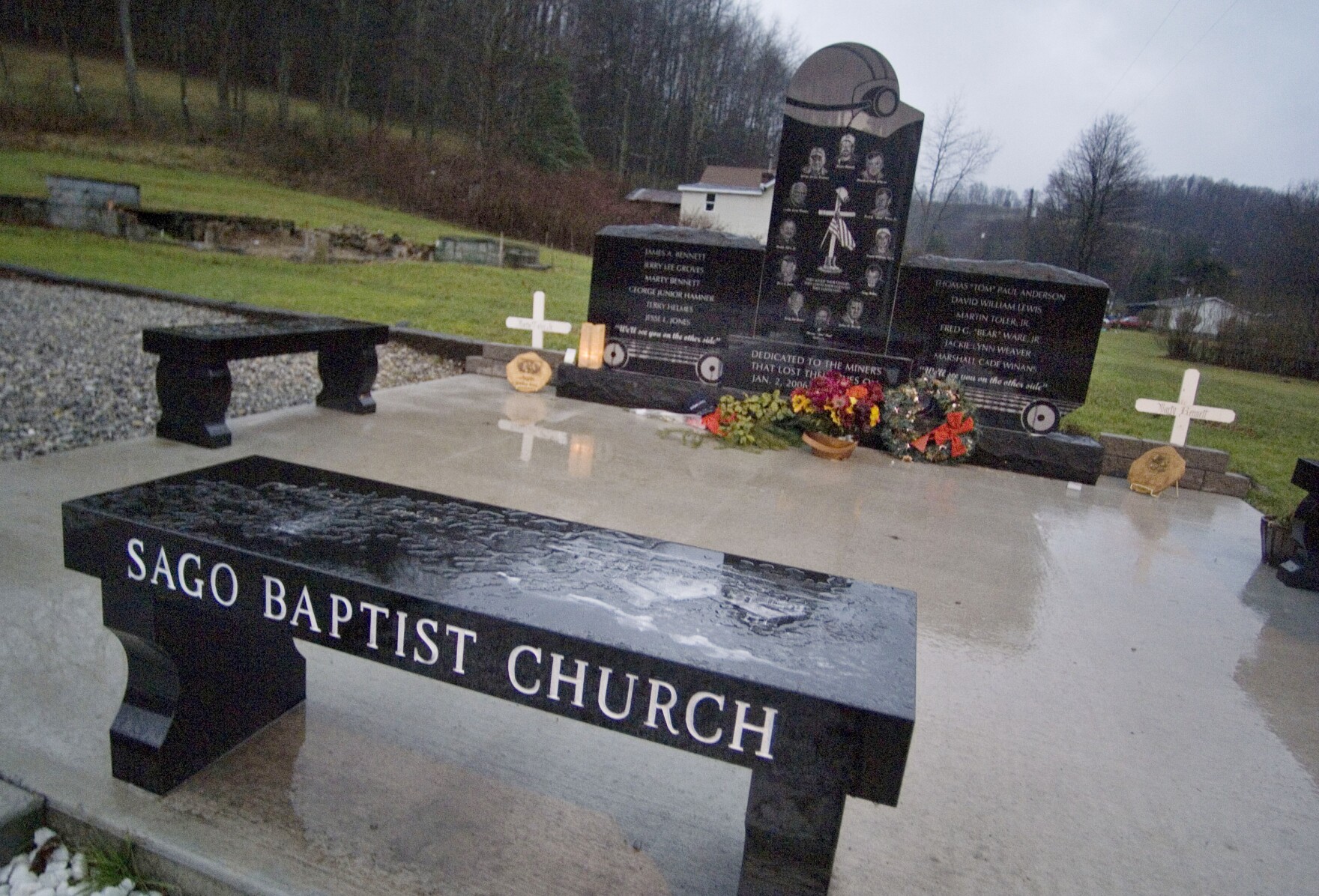 In this Jan. 2, 2007 file photo, crosses, wreaths and a candle lay at the Sago miners' memorial in Sago, W.Va., on the one-year anniversary of the mine explosion that trapped and killed 12 miners near Buckhannon. 