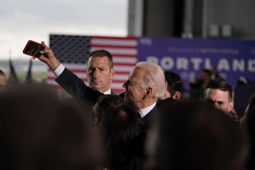 President Joe Biden stops to snap a selfie during a brief visit to Portland.