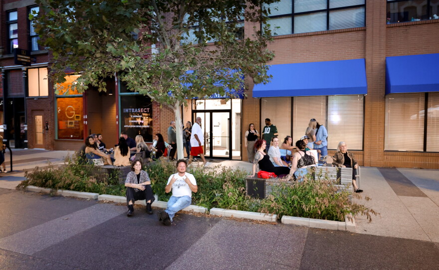 Concertgoers relaxing and enjoying the original local music of the evening.