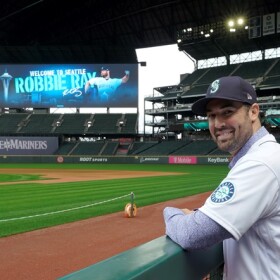 Seattle Mariners pitcher Robbie Ray poses for a photo in the dugout at T-Mobile Park, Wednesday, Dec. 1, 2021, following a news conference in Seattle. The AL Cy Young Award winner — who previously pitched for the Toronto Blue Jays — signed a five-year contract with the Mariners.