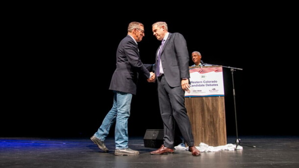 U.S. Rep. Jeff Hurd, incumbent candidate for Colorado's 3rd Congressional District (right), shakes hands with challenger Dwayne Romero after their debate at a Club 20 at the Asteria Theater in Grand Junction. Sept. 19, 2026. (William Woody for CPR News)