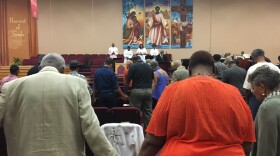 Worshippers bow their heads as the Rev. David A. Keaton leads them in prayer at the Fellowship Missionary Baptist Church in Minneapolis on Sunday.