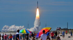 Hundreds of people pack the Canaveral national seashore's Playalinda Beach as a United Launch Alliance Atlas V rocket, carrying a U.S. Navy communications satellite, lifts off from Complex 41 at the Cape Canaveral Air Force Station, Friday, June 24, 2016, in Cape Canaveral, Fla. The satellite is designed to significantly improve ground communications for U.S. forces on the move. (Craig Rubadoux/Florida Today via AP)