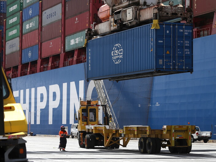 A shipping container is offloaded.