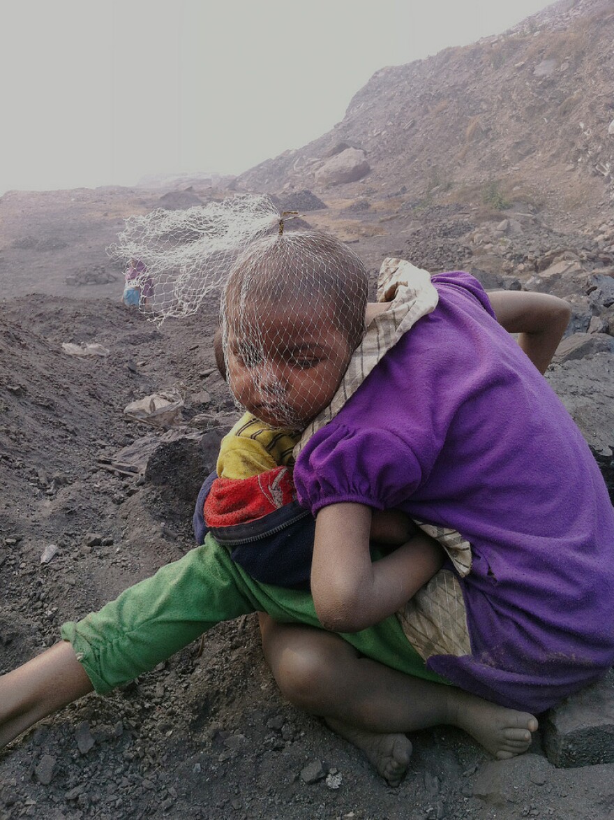 Children wait for their parents — coal pickers at a mine in Jharia — to return from work.