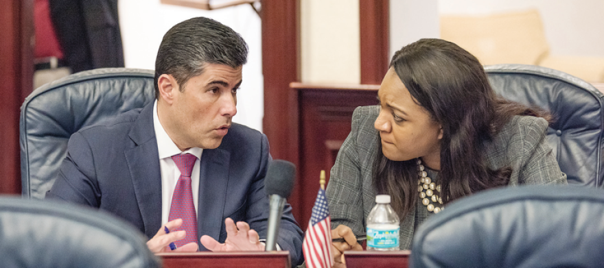Jose Oliva, left, speaks with Fentrice Driskell during a meeting