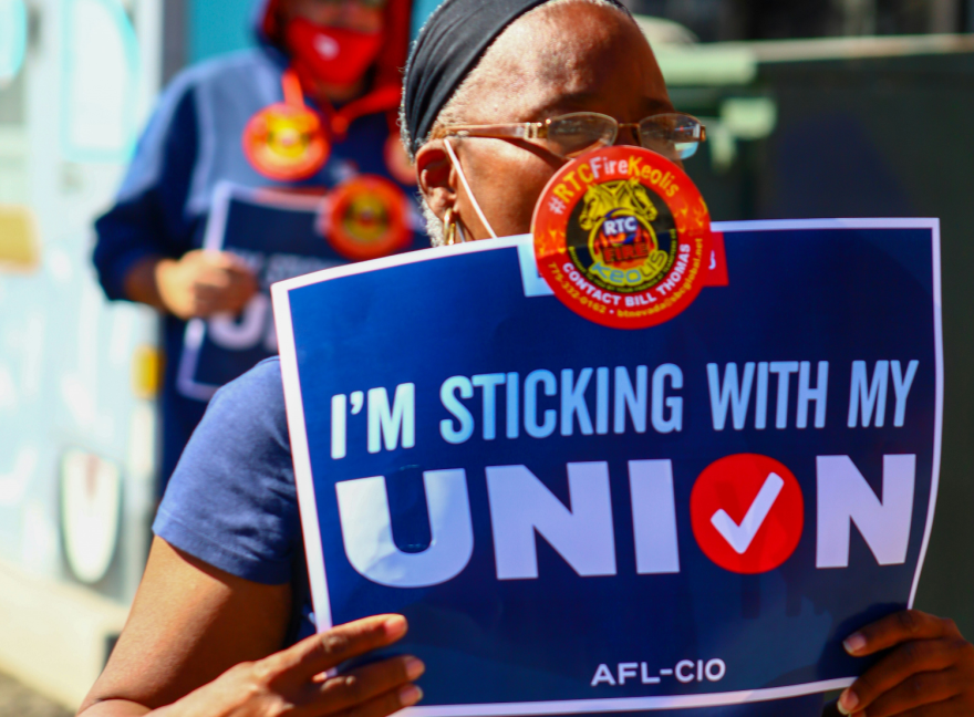 A person carrying a sign that says "I'm sticking with my union, AFL-CIO." Seven in 10 Americans said they support unions, but only one in 10 is a member.