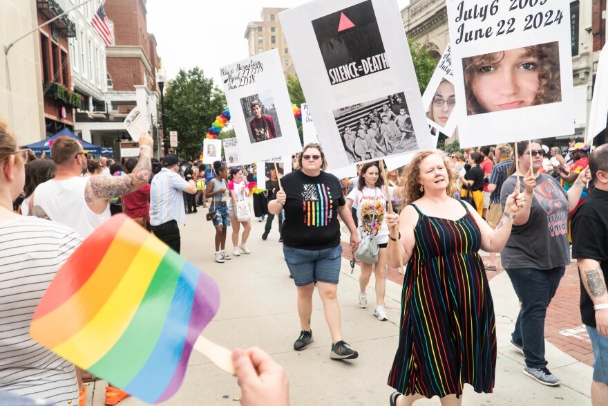Members of the Fresh Air faith community of St. Lucas UCC, walk with posters of victims of anti-LGBTQIA + violence during the Pride parade, Saturday June 7