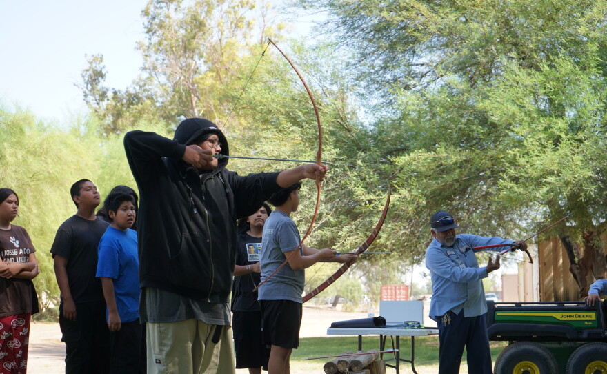 The youth learned archery outdoors as part of the summer program.