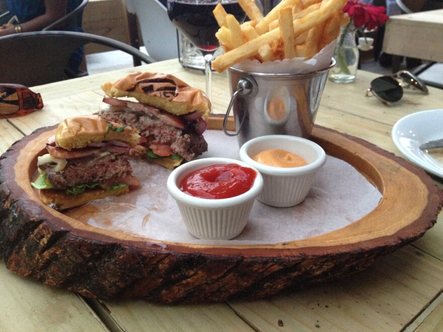 A Hamburger with fries, ketchup and mustard.