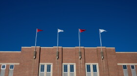 FILE - Flags fly at the Reynolds Coliseum at North Carolina State University Feb. 19, 2022, in Raleigh, N.C.