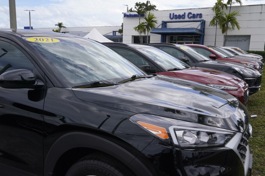 A line of cars for sale at the Potamkin Hyundai dealership used car lot, Tuesday, Feb. 1, 2022, in Miami Lakes, Fla. (AP Photo/Marta Lavandier)