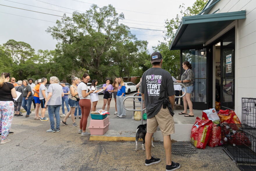 Residents line up outside the Humane Society of North Central Florida on April 19 after the shelter called for emergency foster homes as a wildfire spread nearby.