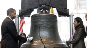 Assistant Secretary for Civil Rights Russlynn Ali and CEO of AmeriHealth Mercy Family Michael Rashid touch the Liberty Bell during a symbolic ringing to mark the observance of Martin Luther King Jr. Day in Philadelphia.