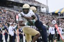 South Florida wide receiver Keshaun Singleton (11) catches a pass for a touchdown in front of Navy cornerback Justin Ross (17) during the first half Saturday, Nov .15, 2025, in Annapolis, Md.