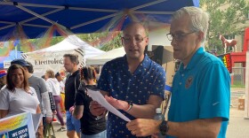 Veterans Affairs Secretary Denis McDonough talks with VA social worker Art Akkerman at a June 2022 LGBTQ Pride event in Denver, Colorado.  