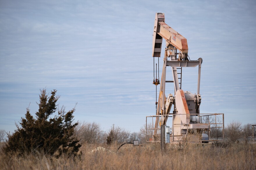 An oil well in a grassy field.