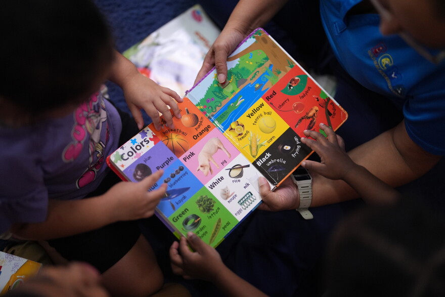 Children look through a book of first words at a Head Start preschool in Immokalee, Fla., Thursday, Sept. 10, 2026.