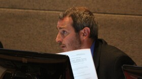 man at computer staring off