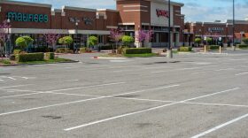 Parking lots were empty in front of several shops in Norman's University Town Center on March 24.